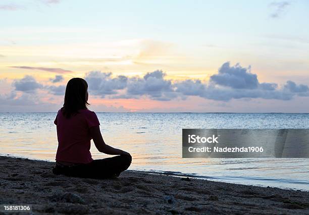 Woman Meditation On Sunset Stock Photo - Download Image Now - Adult, Adults Only, Back Lit