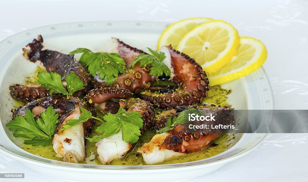 Grilled octopus Grilled octopus with olive oil, lemon, oregano and parsley Grilled Stock Photo