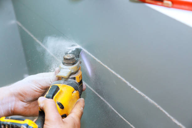 istock To lay an electric cable in wall, you will need to cut plasterboard with use of a multitool 1581836488