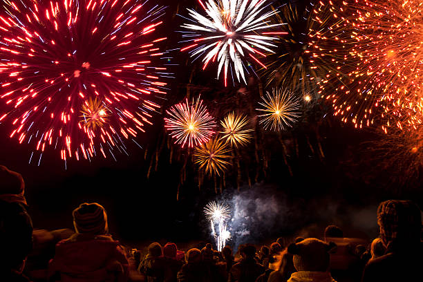 Firework display The crowd looks on at a spectacular firework display firework display photos stock pictures, royalty-free photos & images