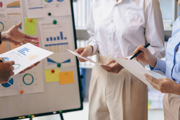 istock A group of young entrepreneurs analyzes reports, graphs summarizing business expenses and job information about the company's financial statements and profitability. 1581851480
