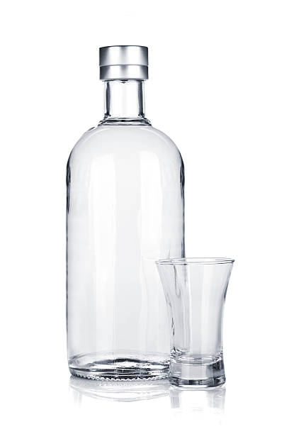 istock Bottle of vodka and empty shot glass 158185197