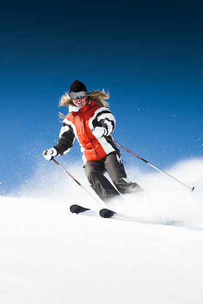 skier is riding from snow hill in the sun beam very fast
