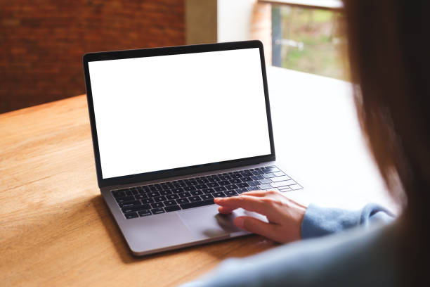 istock Mockup image of a woman using and touching on laptop computer touchpad with blank white desktop screen 1581879154