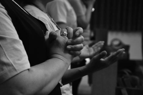 istock Human hand praying together at Church. 1581886787