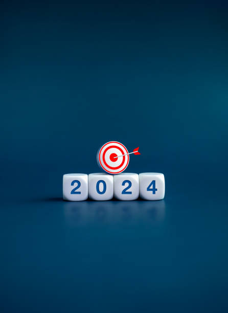 istock The calendar year 2024 with goal and success concept. 3d target icon on white cube blocks with 2024, new year number, isolated on dark blue banner background. Happy new year, business vertical banner. 1581888971