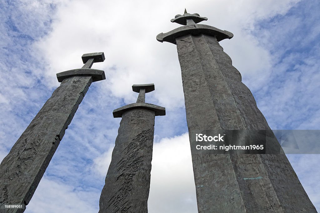 Swords in Rock Three large stone swords against the blue sky. Sword Stock Photo
