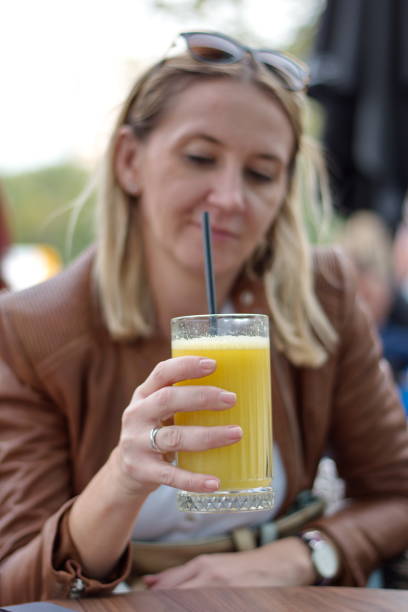 istock Mature woman drinking juice 1581899795