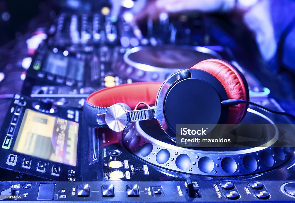 Blue and red disc jockey mixer and headphones Dj mixer with headphones at nightclub Arts Culture and Entertainment Stock Photo