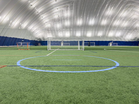 Wide angle view of an empty American football practice field on a summer day