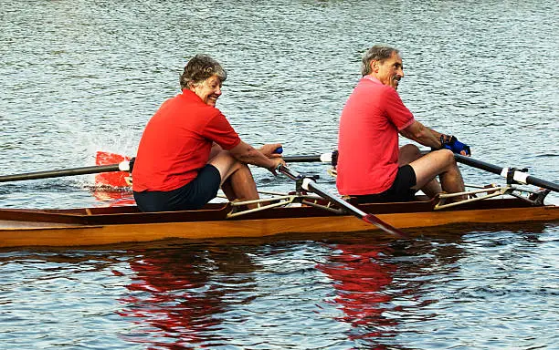 Two people rowing or sculling a racing boat or shell