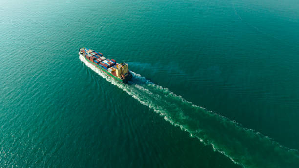istock cargo container ship sailing full speed in sea to import export goods and distributing products to dealer and consumers worldwide, by container ship Transport business delivery service, aerial view 1581979129