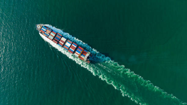 istock cargo container ship sailing full speed in sea to import export goods and distributing products to dealer and consumers worldwide, by container ship Transport business delivery service, aerial view 1581979131