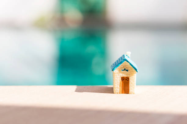 istock Miniature house on swimming pool edge with morning day light 1581982701