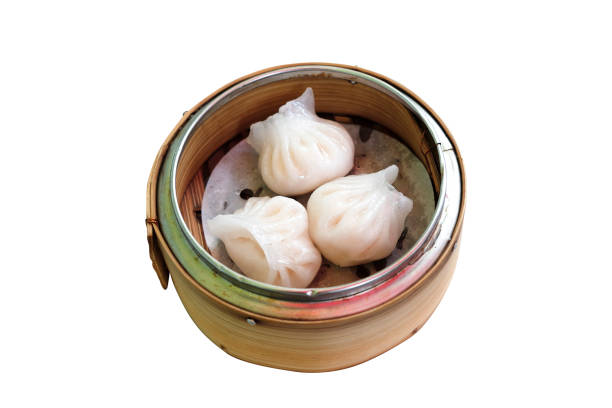 istock Chinese dim sum 'Hagao' in bamboo basket isolated on white 1581988501