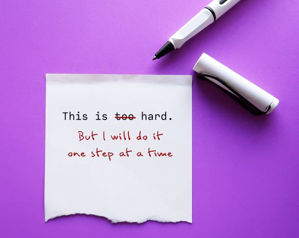 istock On purple copy space background with pen add on torn note message THIS IS TOO HARD with BUT I WILL DO IT ONE STEP AT A TIME, to overcome negative self talk and challenge hard big job management 1582001544