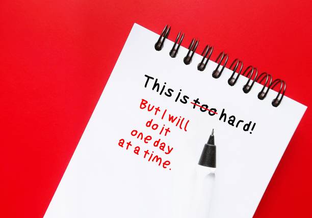 istock On red background with pen on notebook with message THIS IS TOO HARD with BUT I WILL DO IT ONE STEP AT A TIME, to overcome negative self talk and challenge hard big job management 1582001548