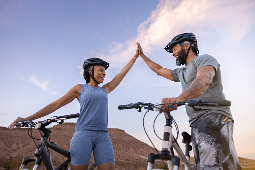 An African American couple enjoying mountain biking in the desert south west