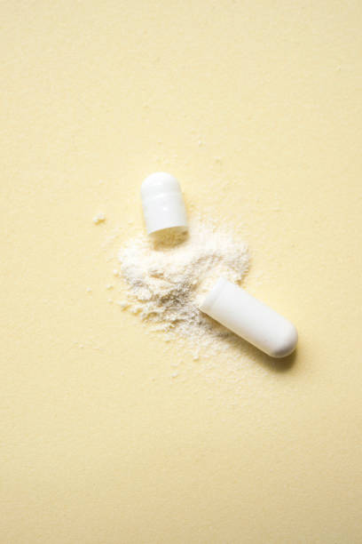 istock opened capsule showing supplement powder on beige colour background 1582009218