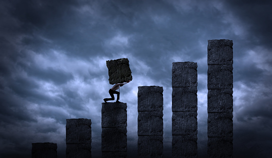 Man Holding The Heavy Weight in a Growing Graph Stairs, Business Steps and Levels Concept. Businessman Carrying a Big Rock Block in Order To Build His Own Growth and Business.