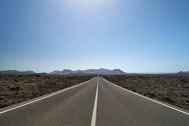 istock Empty and straight road through lava fields on Canary Islands 158203314