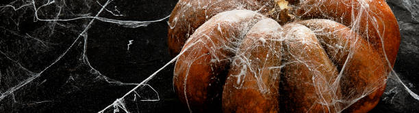 istock Halloween pumpkin on black background. Top view, copy space . 1582077483
