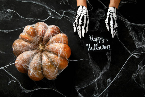 istock Halloween pumpkin on black background. Top view, copy space . 1582088395