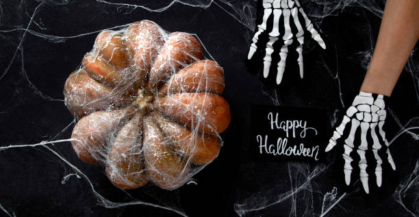 istock Halloween pumpkin on black background. Top view, copy space . 1582091081