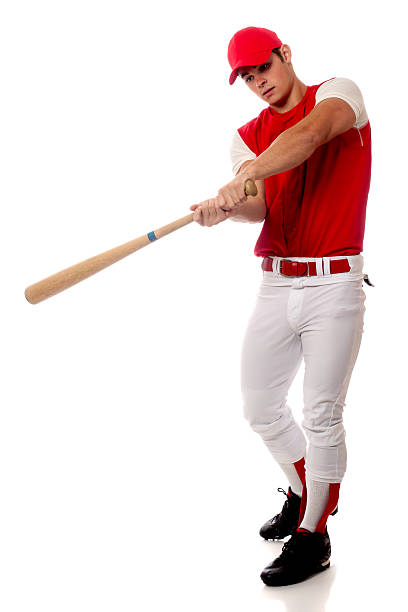 istock Baseball player in red cap holding a bat taking a swing 158210505