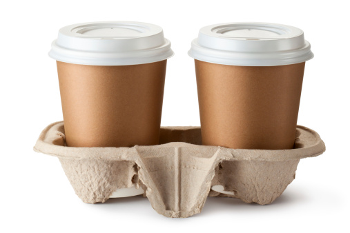 Two take-out coffee in holder. Isolated on a white.