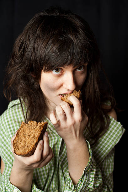 istock beggar woman eating bread 158213132