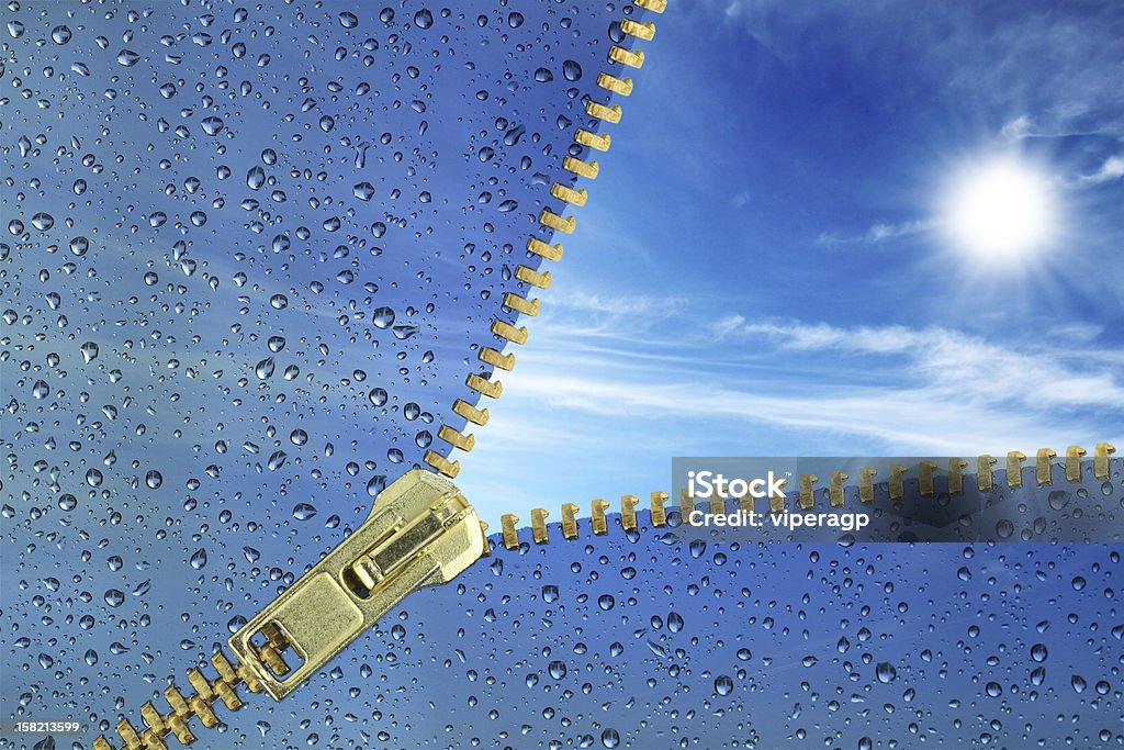 Unzipped glass with water drops revealing blue sky Hopefulness concept.Unzipped glass with water drops revealing blue sky Zipper Stock Photo