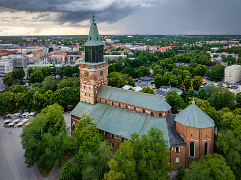 Turku Cathedral, Finnish Turun Tuomiokirkko in Summer situated along the banks of the river Aura and Old Great Square. Aerial Drone Point of View in Summer of Cathedral of Turku. Turku Cathedral is the only medieval Basilica in Finland and the Mother Church of the Evangelical Lutheran Church of Finland. Turku or swedish: Åbo, Southwest Coast of Finland, Finland, Northern Europe, Nordic Countries