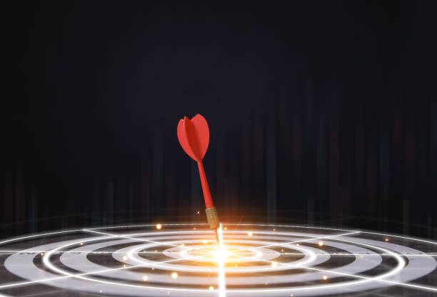 istock Red dart aiming in the center of the target board and digital technology graph. 1582161616