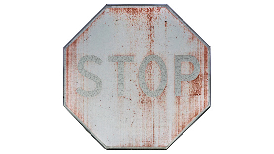Old faded road sign 'Stop' isolated on white