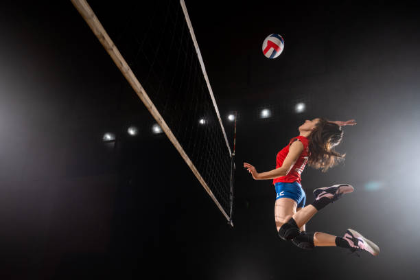 istock Woman spiking volleyball 1582215535