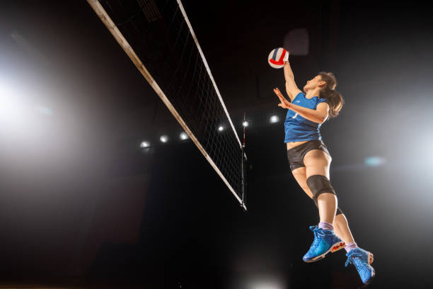 istock Woman spiking volleyball 1582215537