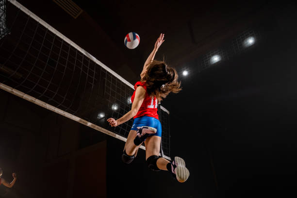 istock Woman spiking volleyball 1582215541
