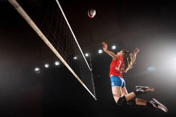 Photo of Woman spiking volleyball