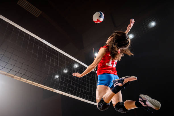 istock Woman spiking volleyball 1582215553