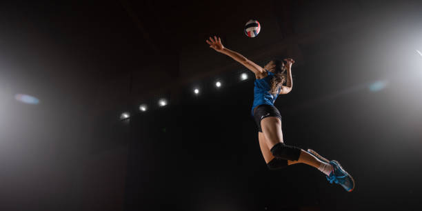 Woman spiking volleyball