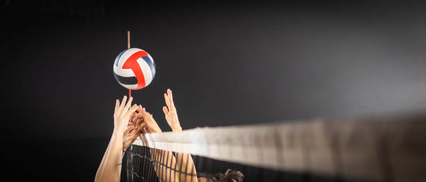 istock Women hands blocking volleyball ball 1582215559