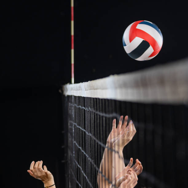 istock Women hands blocking volleyball ball 1582215573