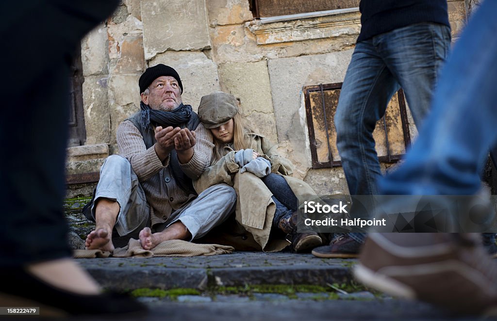 Homeless Homeless family is begging on the street Family Stock Photo