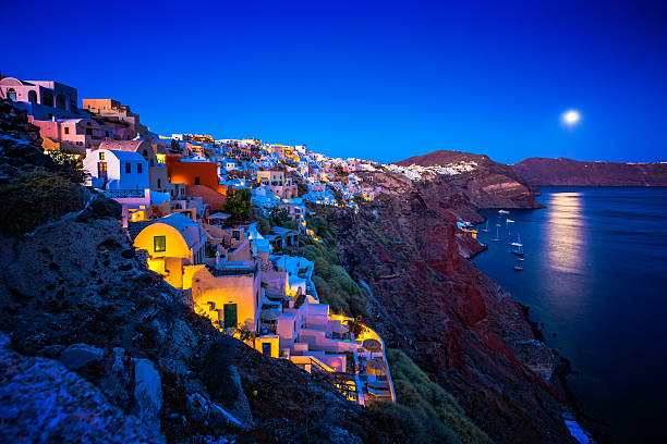 Traditional Greek village Oia (Ia) on Santorini island at full moon in dusk. Click for more images: 