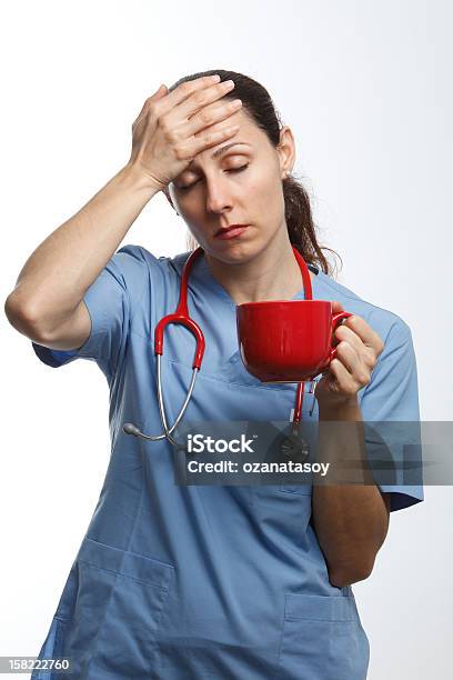 Nurse With A Headache Stock Photo - Download Image Now - Adult, Blue, Brown Hair