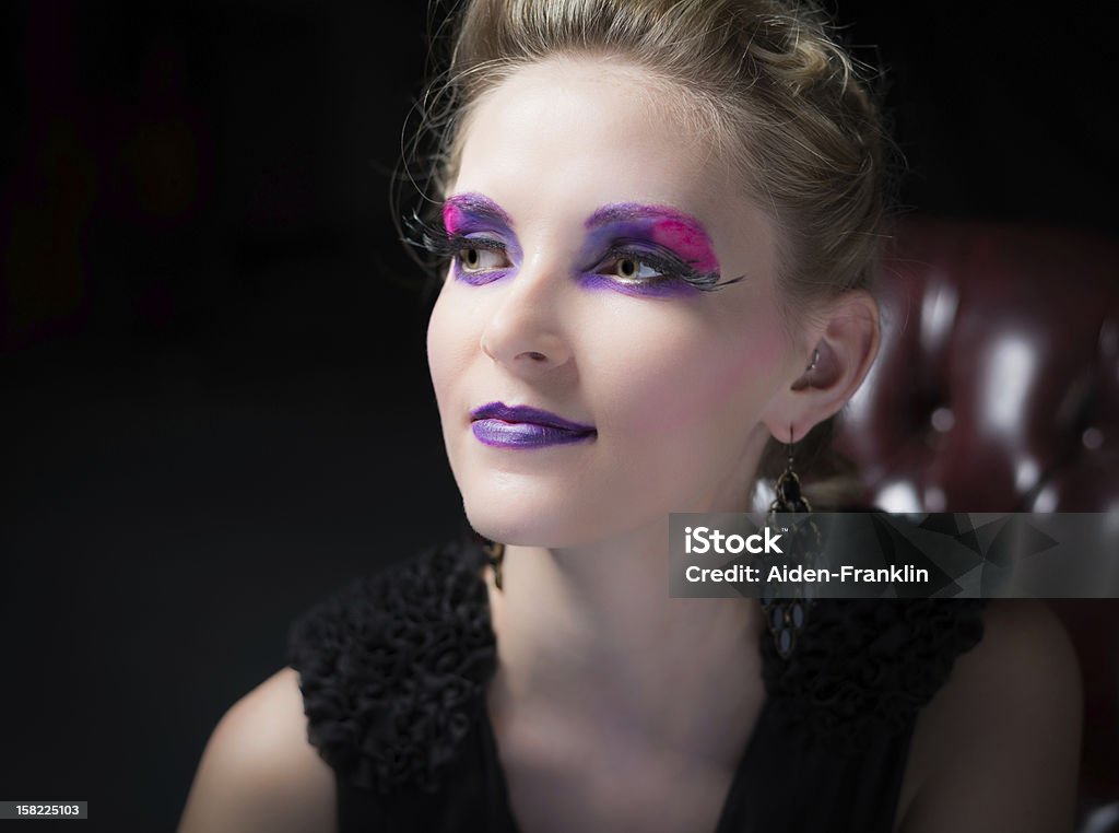 Fashion portrait of young woman in chair. Fashion portrait of young, beautiful, woman in chair wearing heavy make-up. 20-29 Years Stock Photo