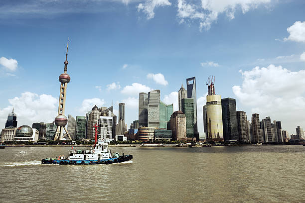 istock shanghai skyline and a tugboat 158225555