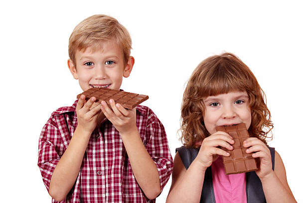 istock boy and little girl eating chocolate 158226078