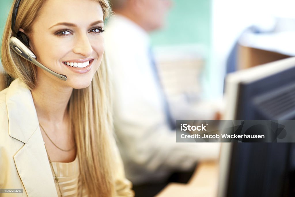 Service Representative - At your assistance Friendly Service Representative in a real office environment Adult Stock Photo